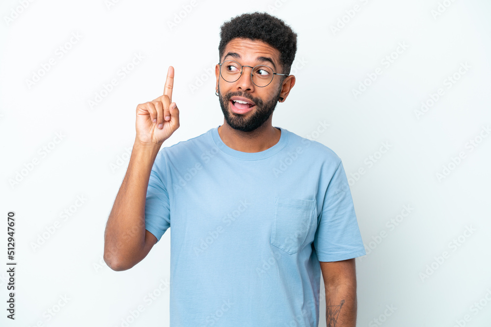 Young Brazilian man isolated on white background intending to realizes the solution while lifting a finger up Young Brazilian man isolated on white background intending to realizes the solution while lifting a finger up