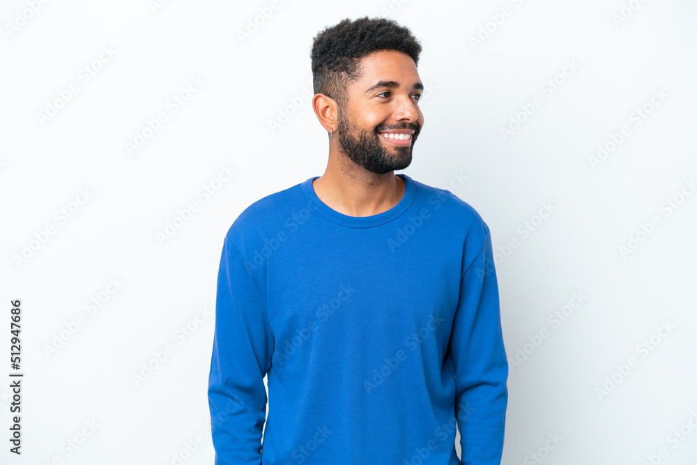 Fototapeta premium Young Brazilian man isolated on white background looking side