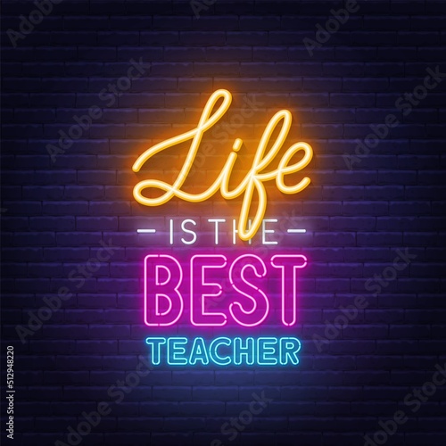 Life is the best teacher neon quote on a brick wall.