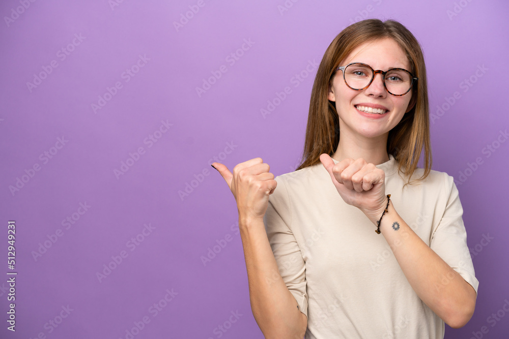 Young English woman isolated on purple background pointing to the side to present a product Young English woman isolated on purple background pointing to the side to present a product