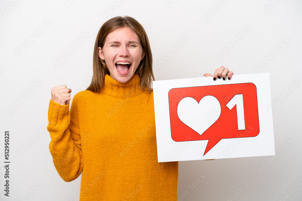 Young English woman isolated on white background holding a placard with Like icon and celebrating a victory Young English woman isolated on white background holding a placard with Like icon and celebrating a victory