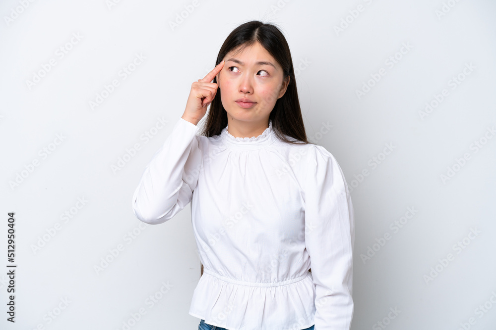 Young Chinese woman isolated on white background making the gesture of madness putting finger on the head Young Chinese woman isolated on white background making the gesture of madness putting finger on the head