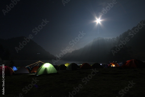 Camping under the moon at night in Ranu Kumbolo, Semeru mountains, Indonesia