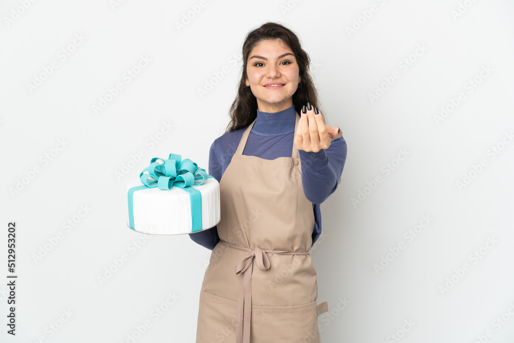Pastry Russian chef holding a big cake isolated on white background inviting to come with hand. Happy that you came Pastry Russian chef holding a big cake isolated on white background inviting to come with hand. Happy that you came