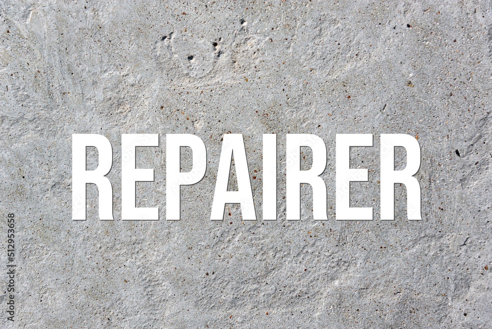 REPAIRER - word on concrete background. Cement floor, wall. REPAIRER - word on concrete background. Cement floor, wall.