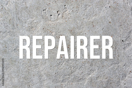 REPAIRER - word on concrete background. Cement floor, wall.