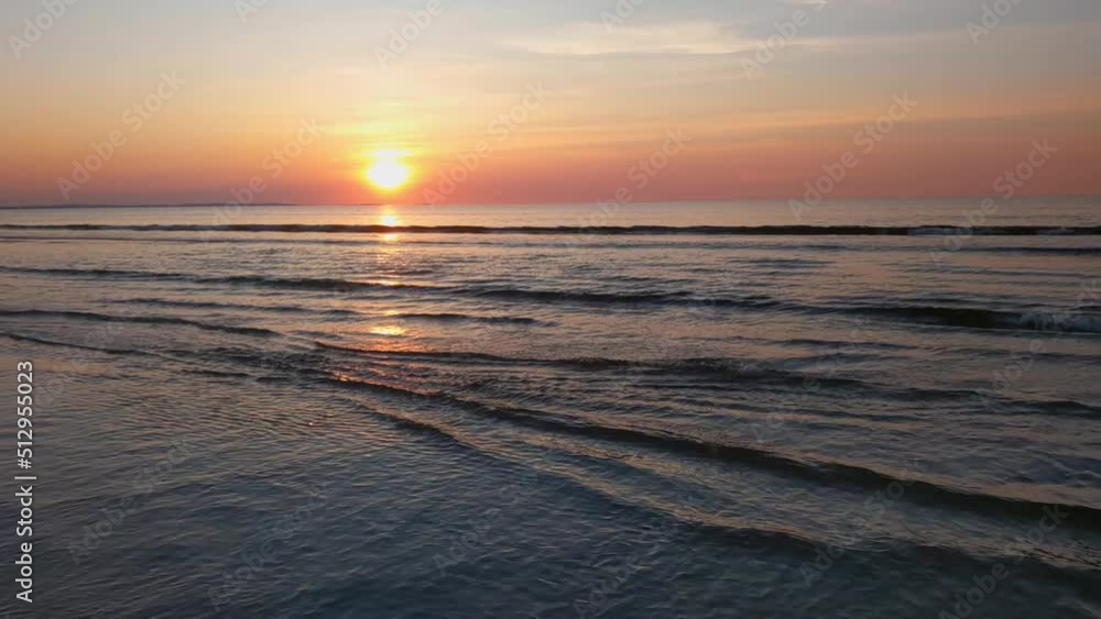 Beautiful picturesque sunset on the seashore. Waves roll on the sandy shore. Rest in warm countries. Vacation Beautiful picturesque sunset on the seashore. Waves roll on the sandy shore. Rest in warm countries. Vacation