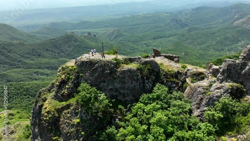 Timelapse of Kojori Fortress near Kojori, Georgia. Tourists visit landmark, look on beautiful valley with sunbeams. Christian cross on the hill near Kojori Fortress. photo