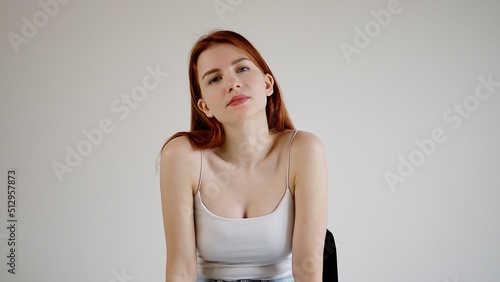 Attractive young woman looks tired into the camera.