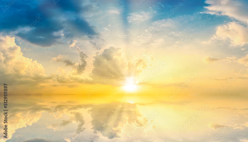 Fototapeta premium Sky blue and orange light of the sun through the clouds in the sky