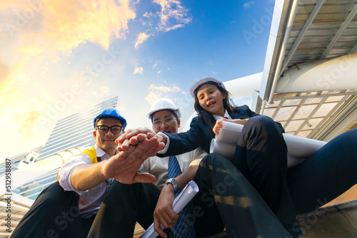 group of friends, Asian business team Architects and engineers and business women join hands.