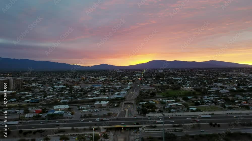 Amazing Sunset And Mountain View Amidst A Busy City - aerial shot Amazing Sunset And Mountain View Amidst A Busy City - aerial shot