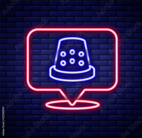 Glowing neon line Thimble for sewing icon isolated on brick wall background. Colorful outline concept. Vector