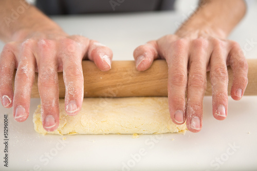 male hands are rolling dough