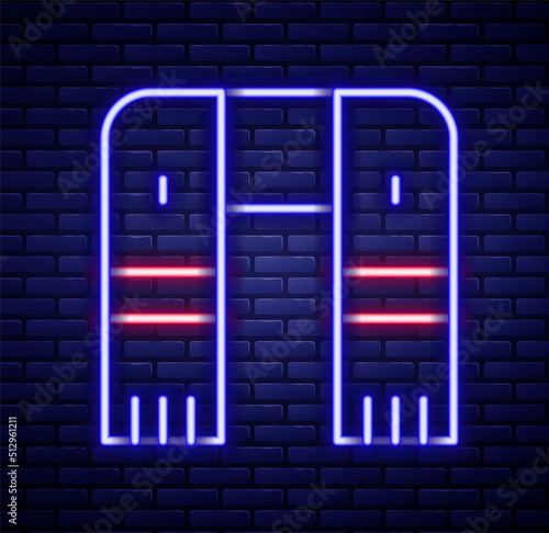 Glowing neon line Winter scarf icon isolated on brick wall background. Colorful outline concept. Vector