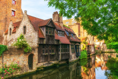 Bruges, Belgium - Cityscape overlooking old quiet streets with old brick houses and a canal on a summer sunny day.