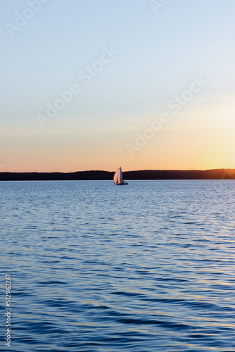 sailing on the sea on a yacht at sunset on a summer evening © VOLHA VAITSIAKHOVICH