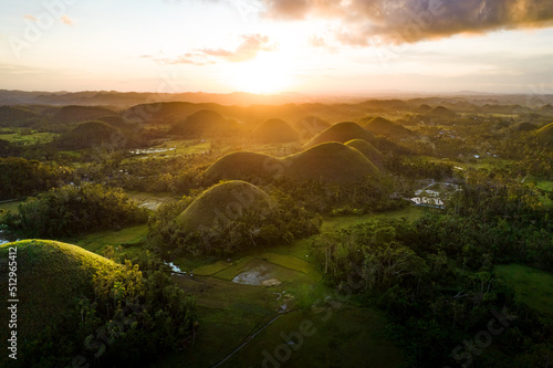 Stunning drone views of the famous Chocolate Hills mountain formations at sunset in Bohol, Philippines
