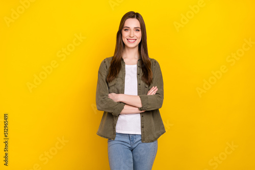Photo of cheerful good mood intelligent business lady with folded arms posing on camera isolated on yellow color background
