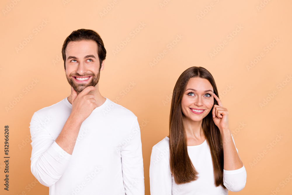 Portrait of attractive cheerful bewildered brown-haired people making decision isolated over beige pastel color background Portrait of attractive cheerful bewildered brown-haired people making decision isolated over beige pastel color background