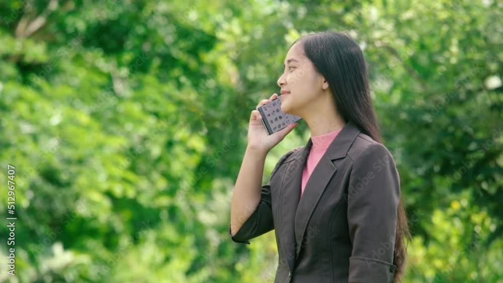 Young businesswoman making a call with a smile Young businesswoman making a call with a smile