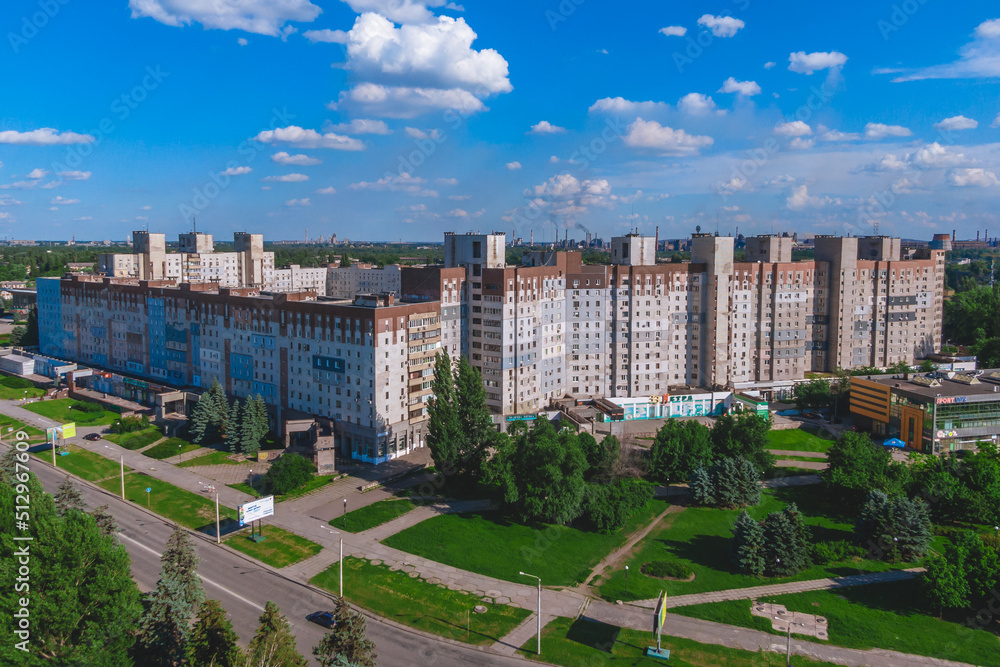 A multi-storey building where the parents of President Zelensky live. in the background ArcelorMittal Krivoy Rog, Ukraine