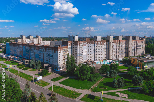 A multi-storey building where the parents of President Zelensky live. in the background ArcelorMittal Krivoy Rog, Ukraine
