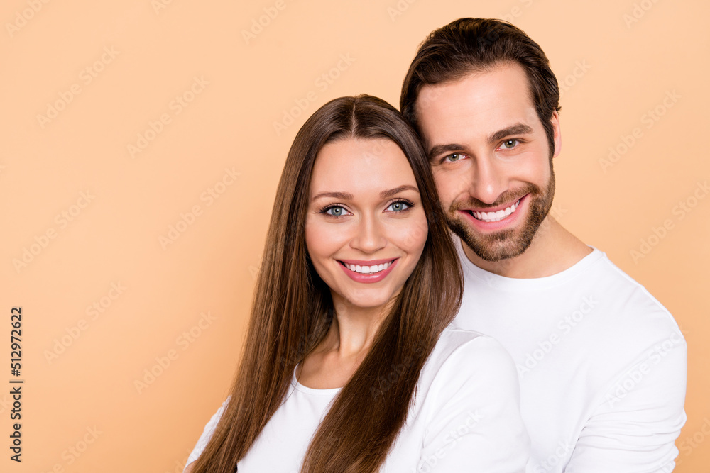Photo of nice millennial brown hairdo couple hug wear white cloth isolated on beige color background Photo of nice millennial brown hairdo couple hug wear white cloth isolated on beige color background