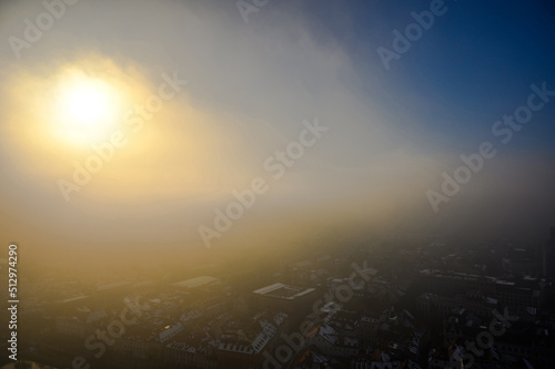 Landscape view on the Ljubljana city from the castle during a windy foggy sunny weather in the winter