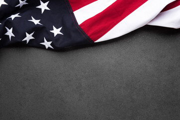 The flag of the United States of America on a gray textured background with copy space