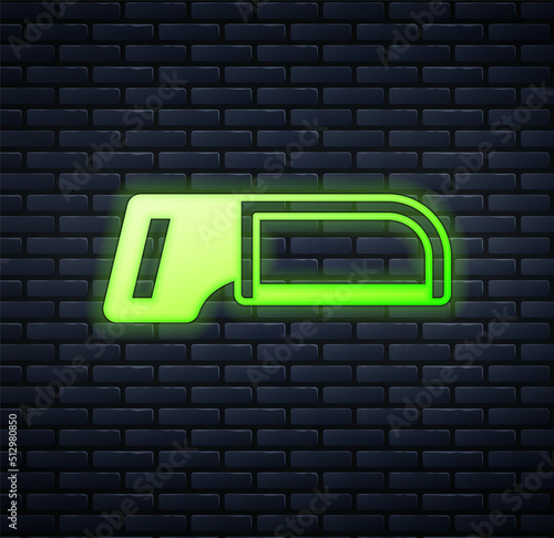 Glowing neon Hacksaw icon isolated on brick wall background. Metal saw for wood and metal. Vector