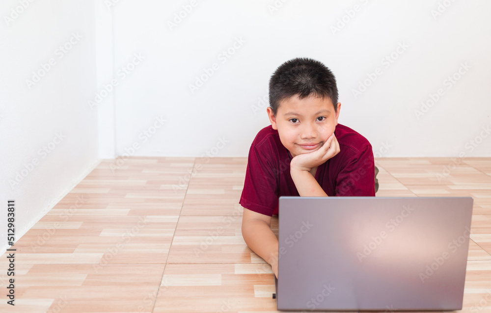 Asian boy studying online on computer laptop with smiling and happy face at home. online education and e-learning concept. Asian boy studying online on computer laptop with smiling and happy face at home. online education and e-learning concept.