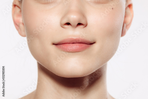 Closeup female lips, cheeks and nose isolated over white studio background. Concept of cosmetology, skincare, cosmetics, plastic surgery, ad