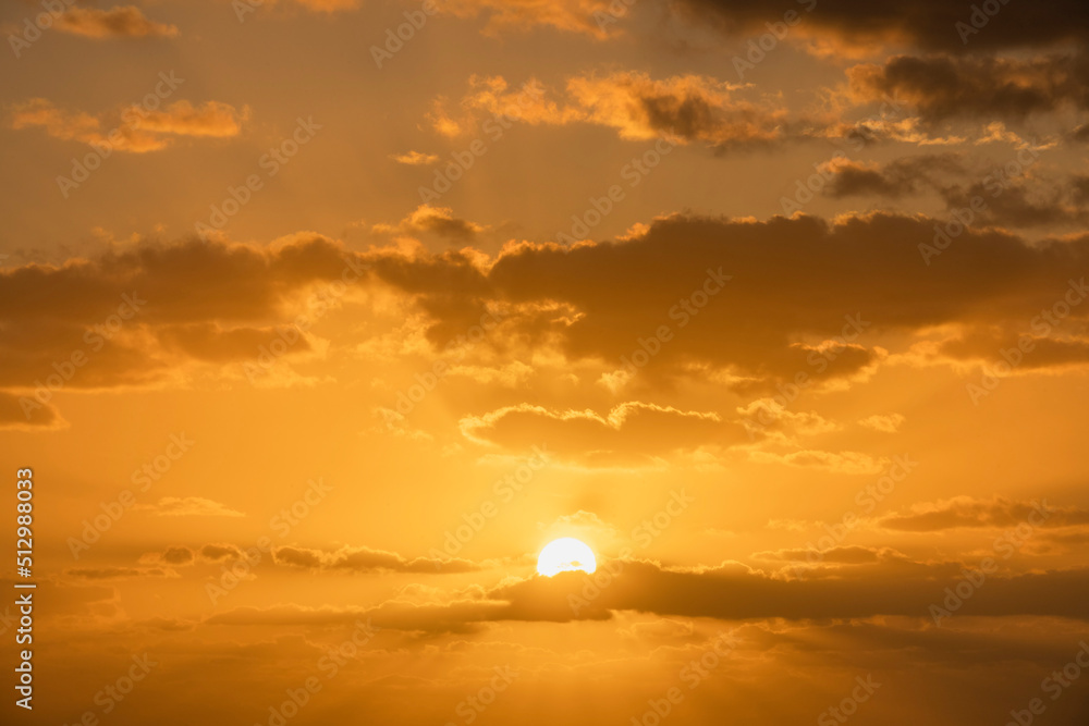 Golden sunrise sky with cumulus clouds and sun Golden sunrise sky with cumulus clouds and sun