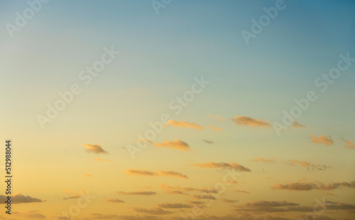 Blue sky with small calm clouds at sunrise photo