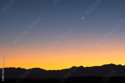 USA, New Mexico, Santa Fe, Jemez Mountains at dusk with crescent moon on sky