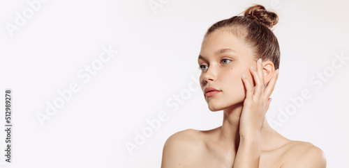 Portrait of young, beautiful and healthy girl with well-kept skin isolated on white background. The spa, surgery, face lifting and skin care concept photo