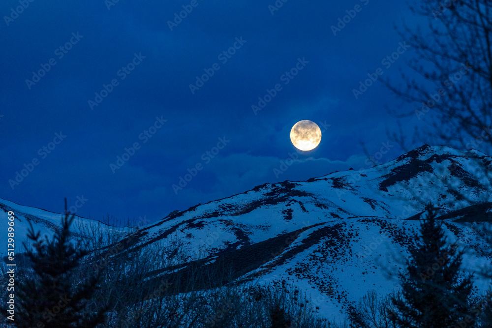 © Tetra Images - USA, Idaho, Bellevue, Full moon over snow covered hills at night