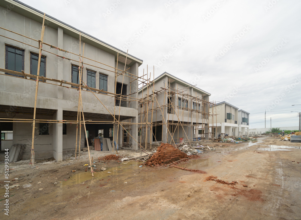 Under construction home or house with scaffolding on site in village. Interior. Old unfurnished room rental property, living space units. lifestyle. Renovation.