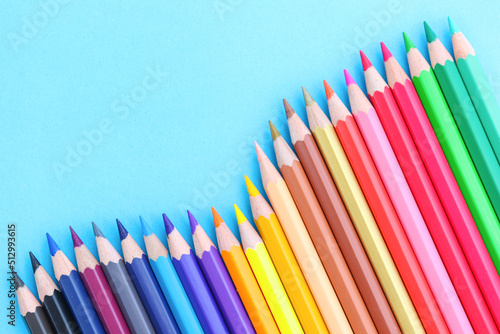 colored pencils with copy space on blue background educational concept