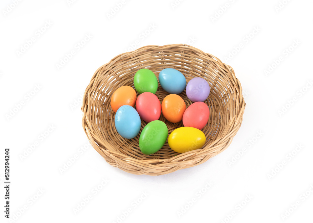 Colorful easter eggs on a basket and white background. Food decoration on holiday. Colorful easter eggs on a basket and white background. Food decoration on holiday.