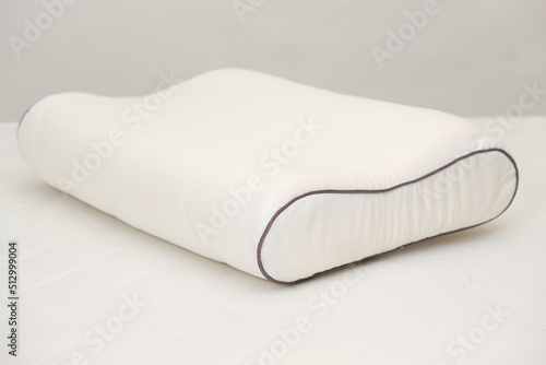 Orthopedic pillow made of memory foam on a white background. A Useful Right Pillow for Healthy Sleep. photo