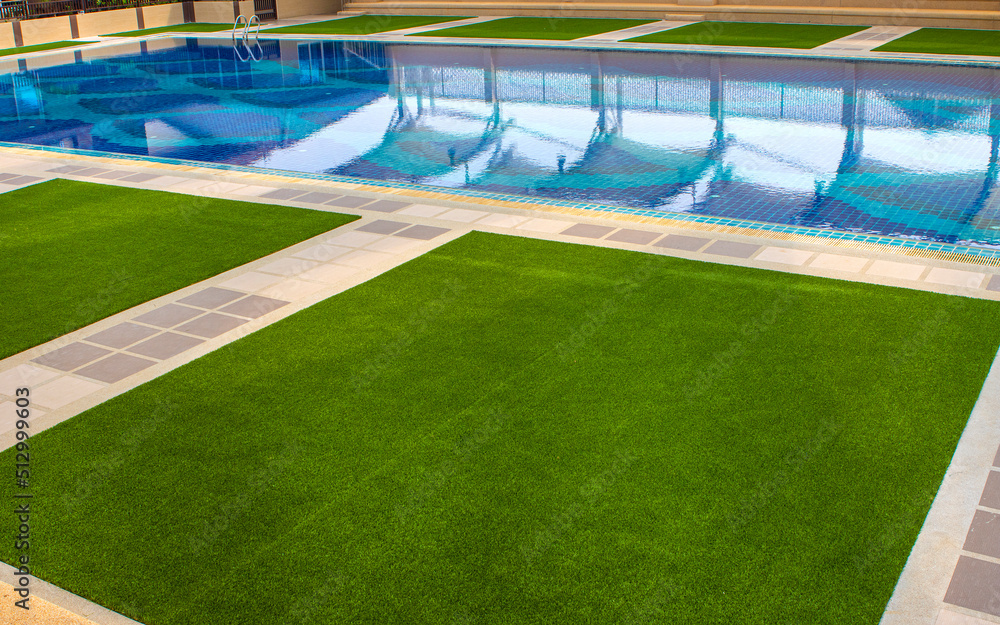 Naklejka premium Green the artificial turf by the pool