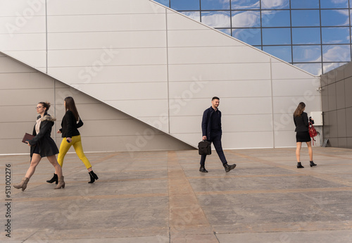 Walking fast all together while smiling in front of the company