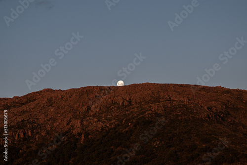 The day before the full moon, the moon rises behind the mountains of Córdoba photo