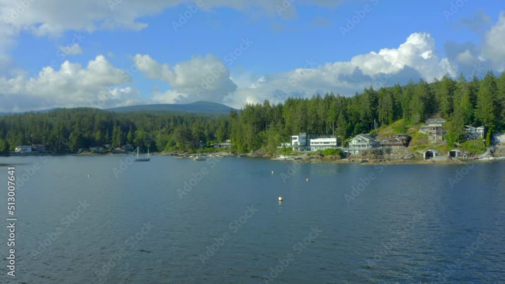 Establishing aerial shot of ocean beach with rocks and pebbles in slow motion at summer day in Vancouver, Canada, North America. Day time on September 2021. Drone forward. ProRes 422 HQ. Establishing aerial shot of ocean beach with rocks and pebbles in slow motion at summer day in Vancouver, Canada, North America. Day time on September 2021. Drone forward. ProRes 422 HQ.