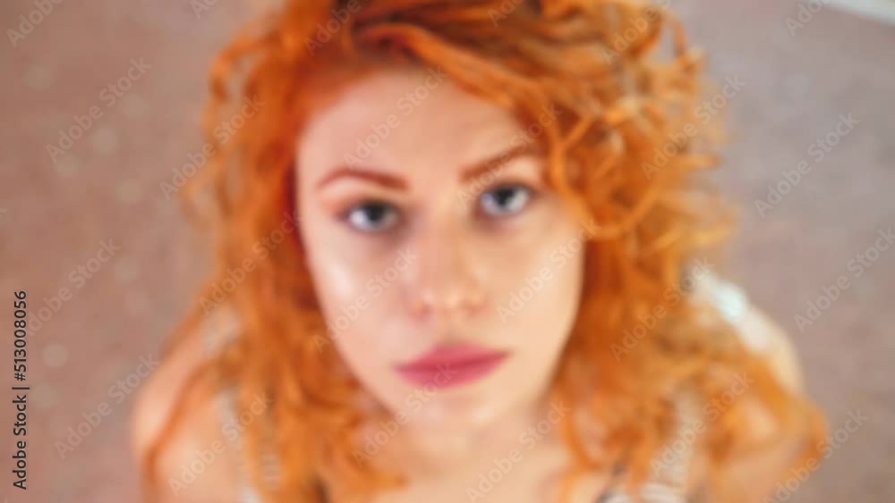 steady cam on pensive woman stares at the camera thoughtfully - unfocused steady cam on pensive woman stares at the camera thoughtfully - unfocused