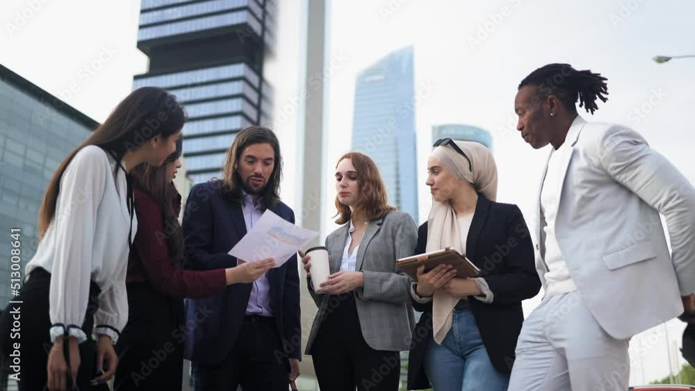 Multiracial business people having a briefing outside the office Multiracial business people having a briefing outside the office