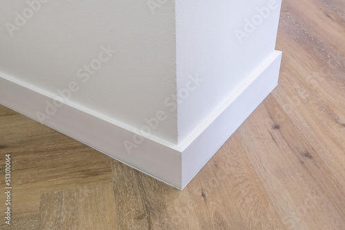 Detail of corner flooring with intricate crown molding and plinth. photo