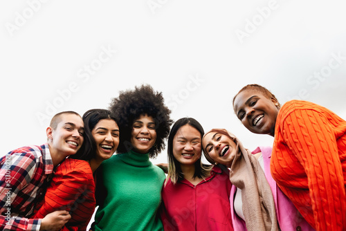 Happy young multi ethnic women having fun hanging out in the city